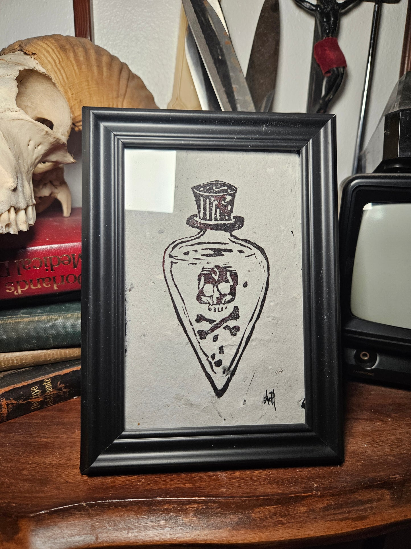 Framed poison bottle linocut