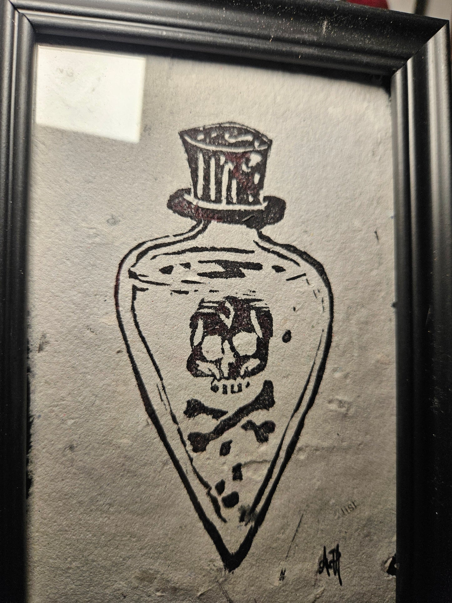 Framed poison bottle linocut